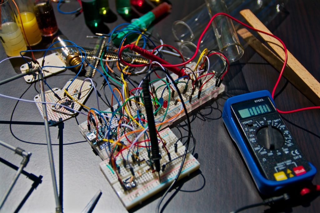 Electrical wires from a circuit board on a table