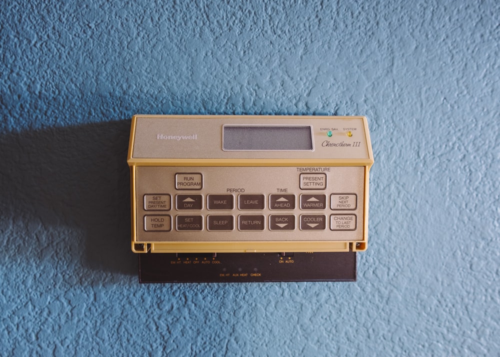 Close up of an old thermostat and temperature control system